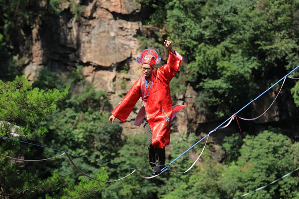 Participants race on a slackline suspended in Zhangjiajie